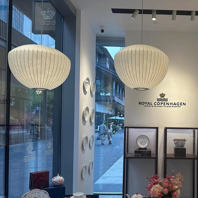 White Wabi Sabi pendant lamp hanging above a styled dining display