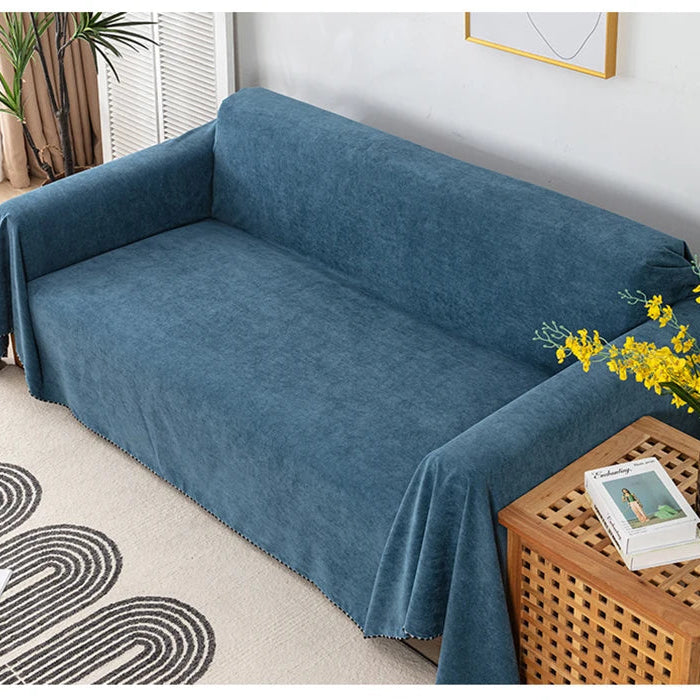 Navy blue sofa cover on a sofa with decorative elements in the background