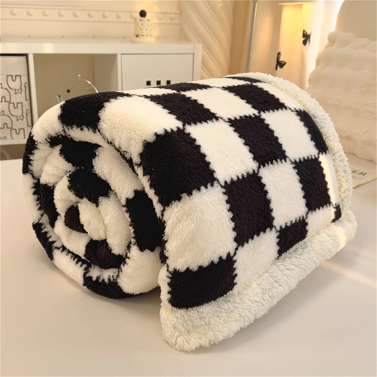 Black and white checkered blanket on a light surface