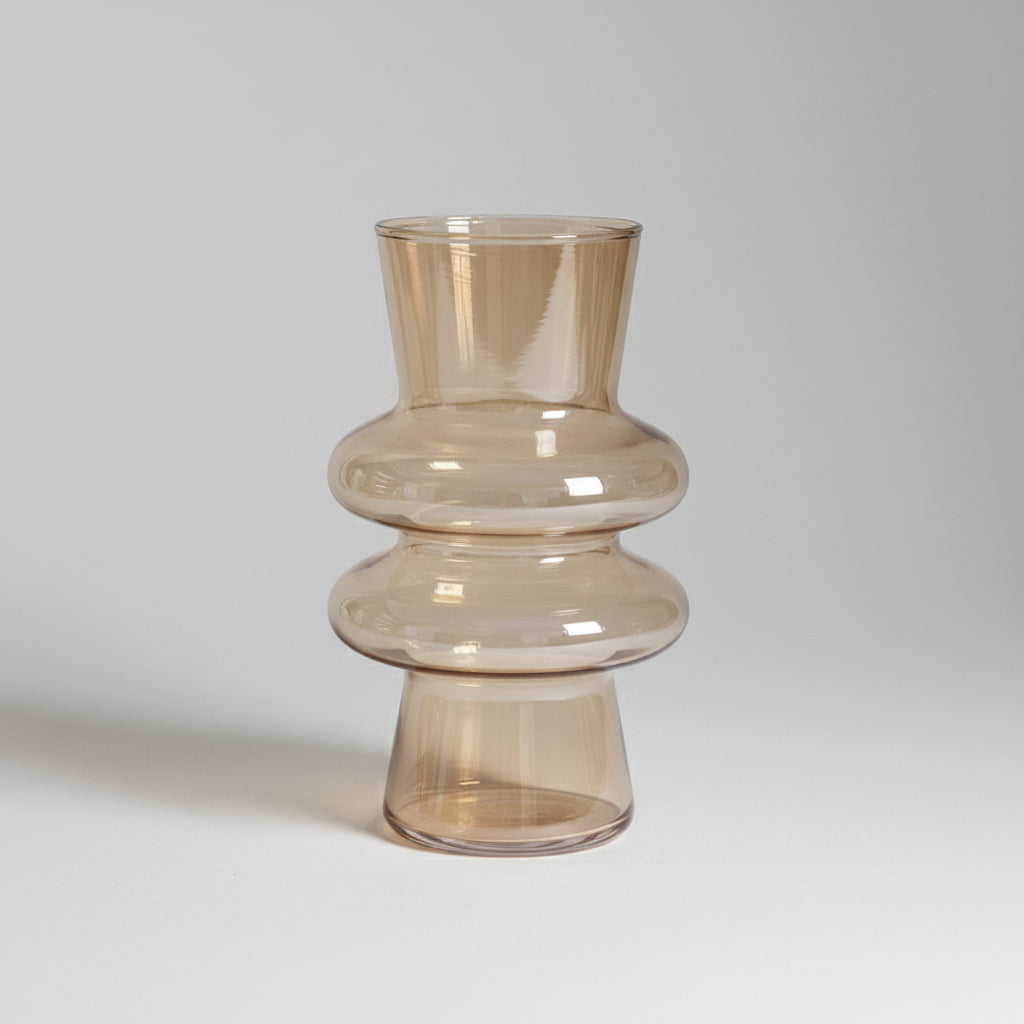 An amber glass vase on a book with measurements indicated