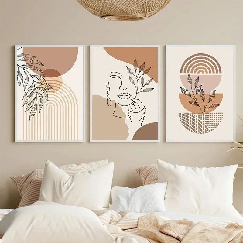 Three abstract art prints on a wall above a bed with neutral tones.