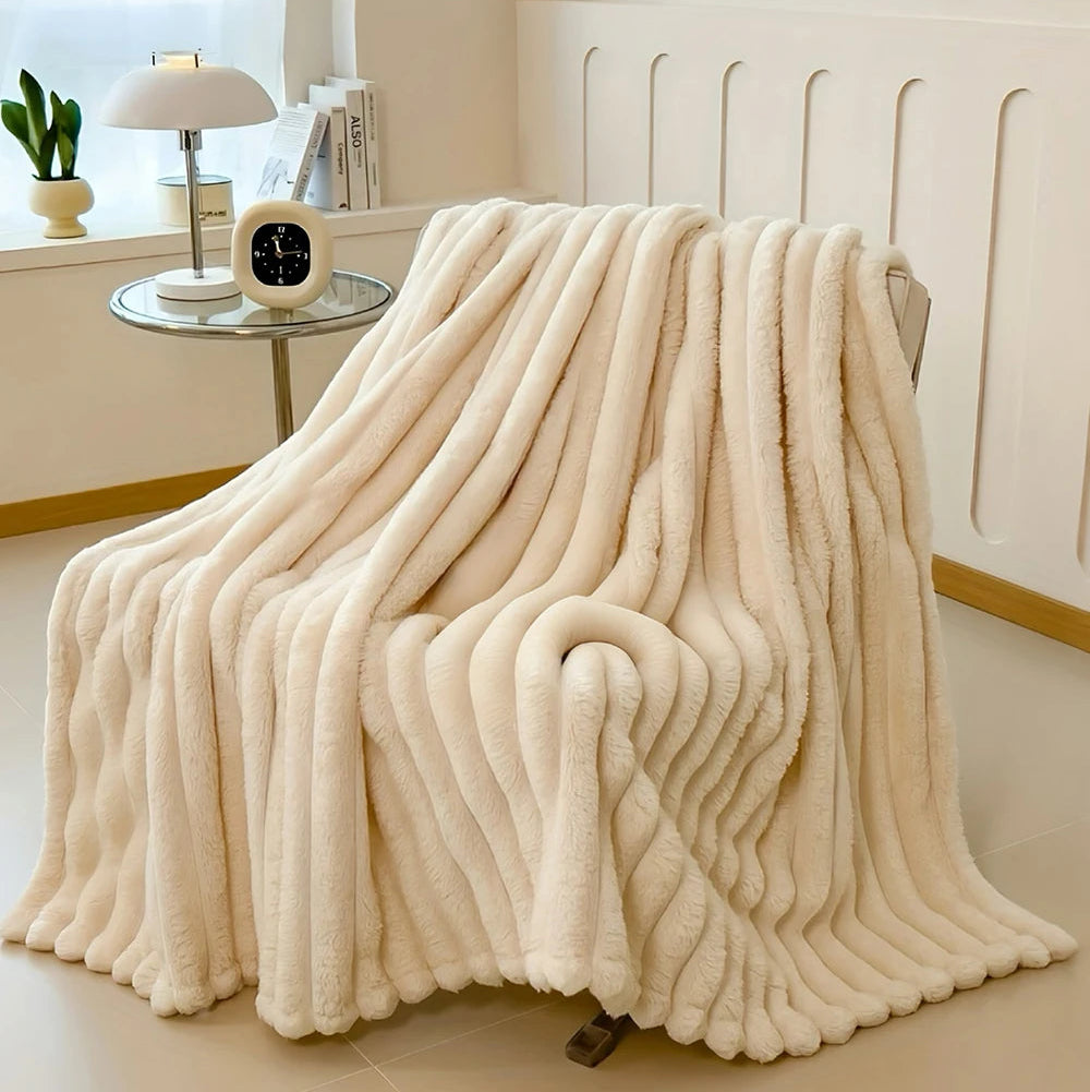 Beige blanket draped over a chair in a room with a window and decor.