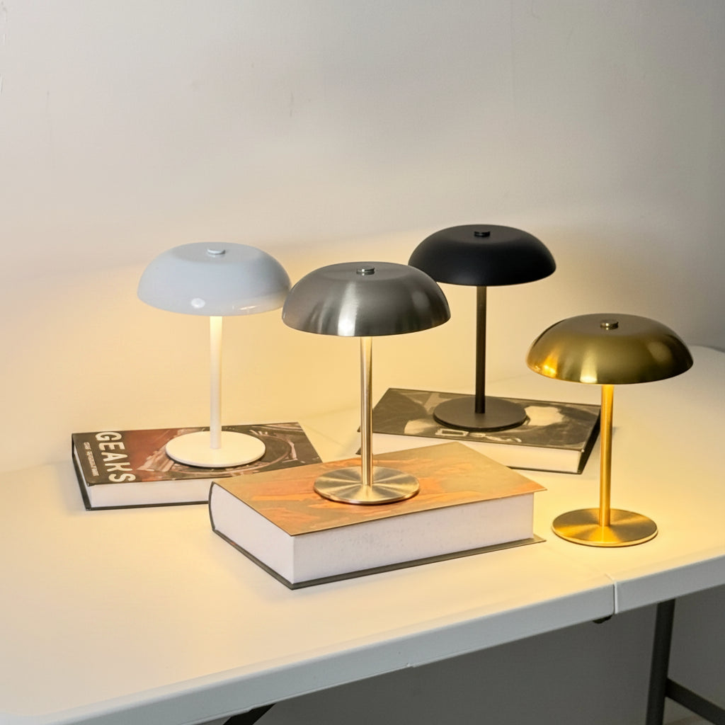 Set of colourful mushroom table lamps on books with a neutral background