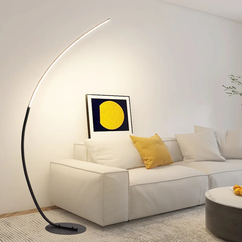 Modern living room with a white sofa, yellow pillow, and a floor lamp.