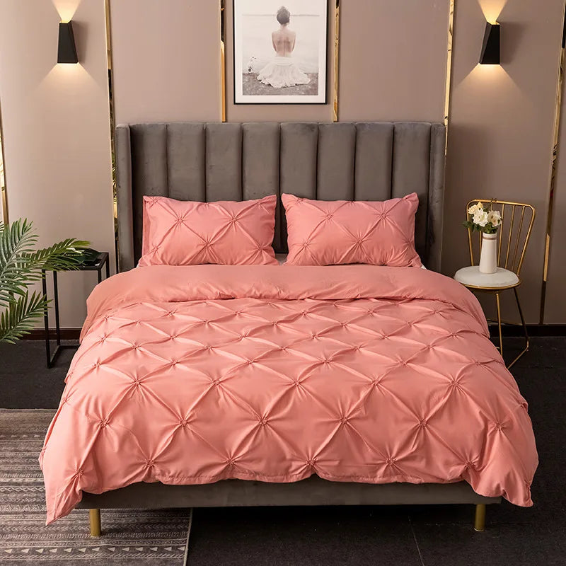 Coral pink 3D pinch pleated duvet cover set styled on a bed with matching pillowcases.