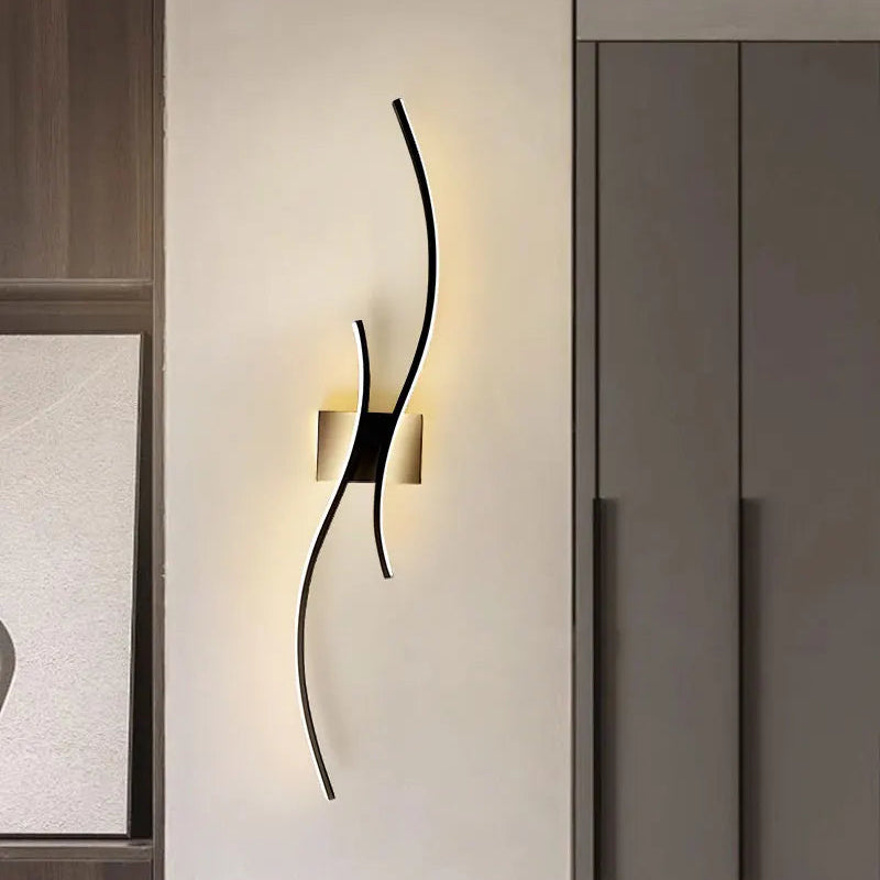 Modern black wall sconce in a dining room setting with chairs and a window.