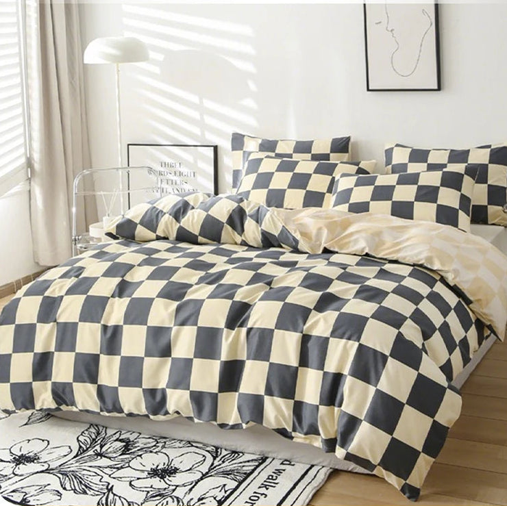 Checkered duvet cover set with two pillowcases on a bed in a bedroom.