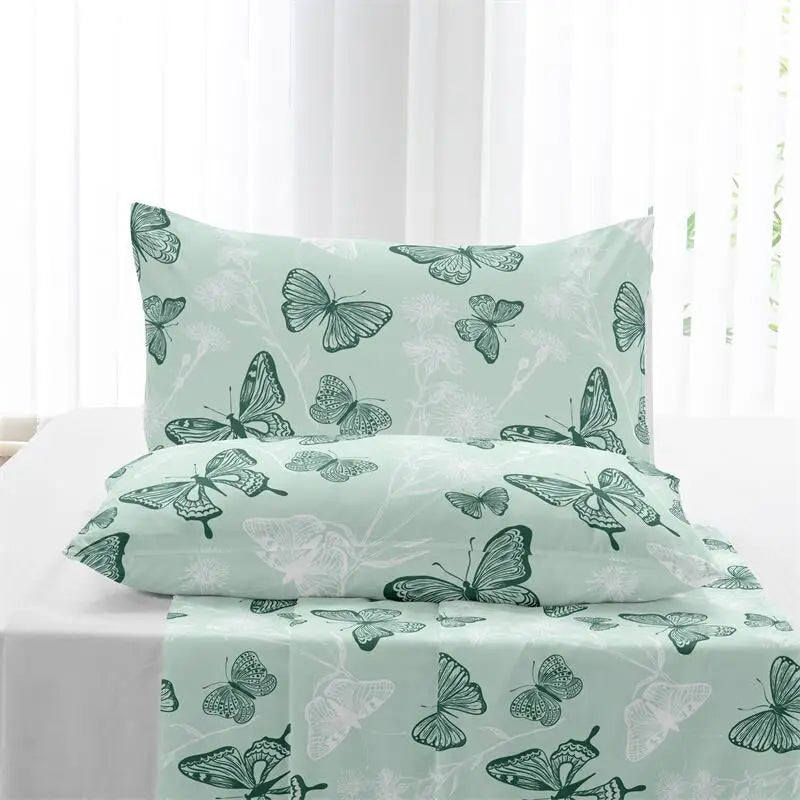 Sage-green butterfly-print duvet cover set with matching pillowcases in a styled bedroom.