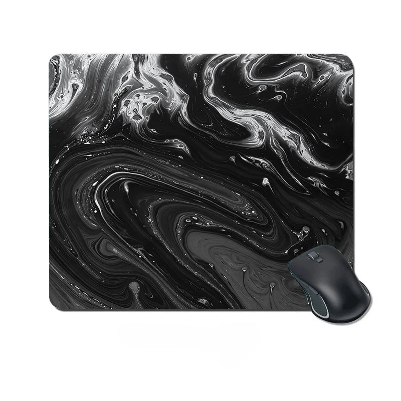 Black and white marbled mouse pad with a mouse on a white background