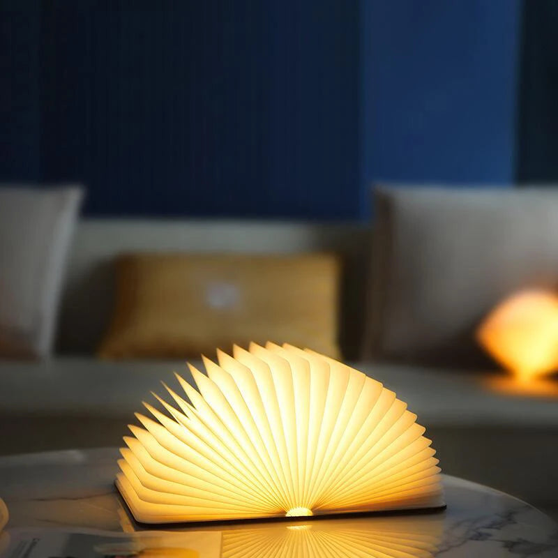 Book-shaped lamp on a table with a blurred background