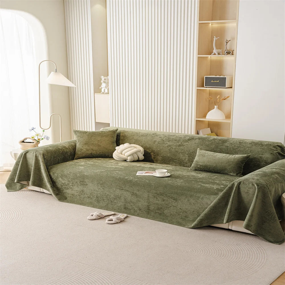 Soft-touch olive sofa throw styled in a minimalist living room