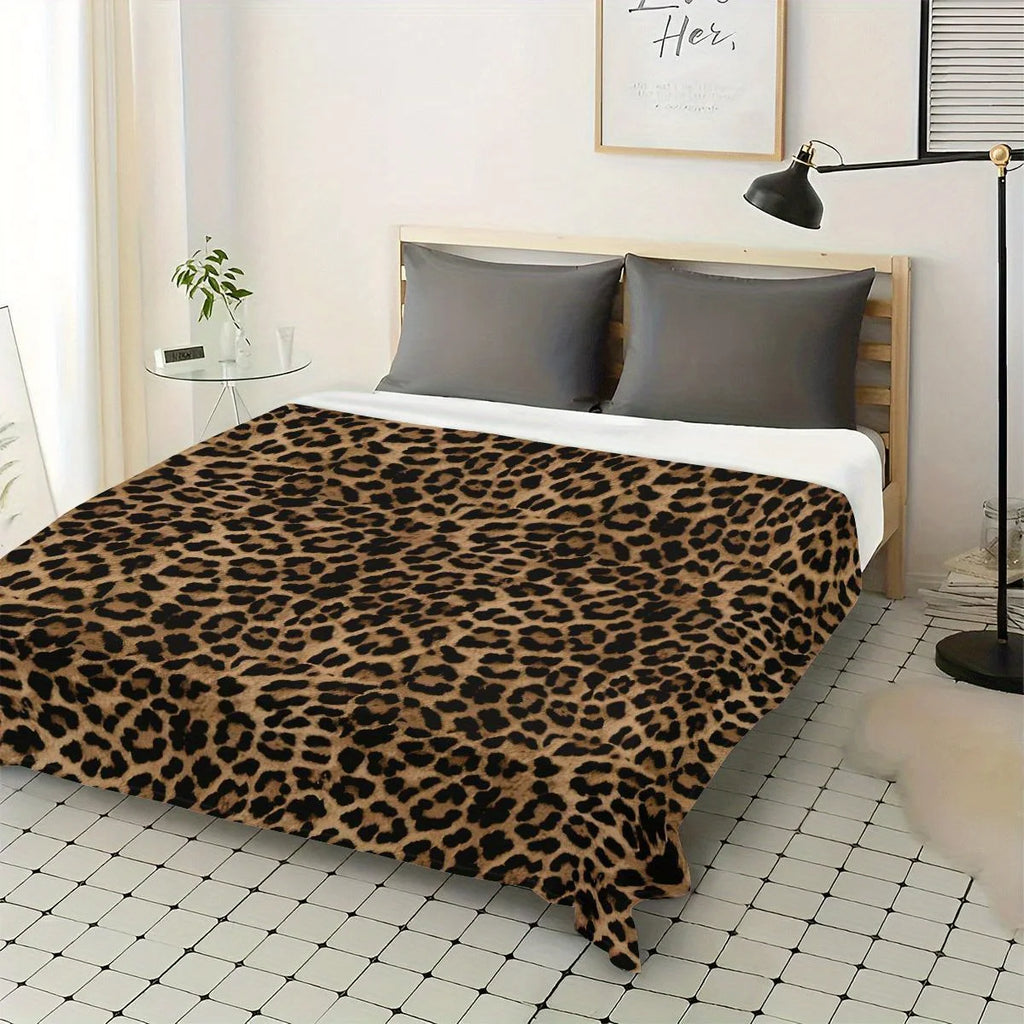 Soft tiger pattern fleece blanket on a bed.