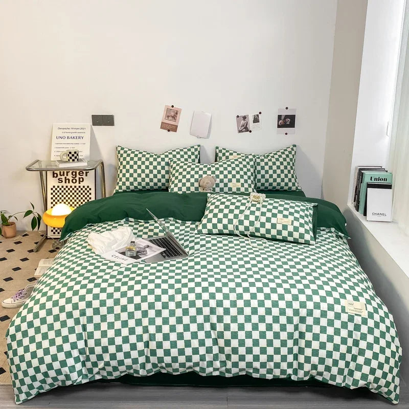 Forest green and white checkerboard duvet cover set with matching pillowcases dressed on a double bed in a modern styled bedroom