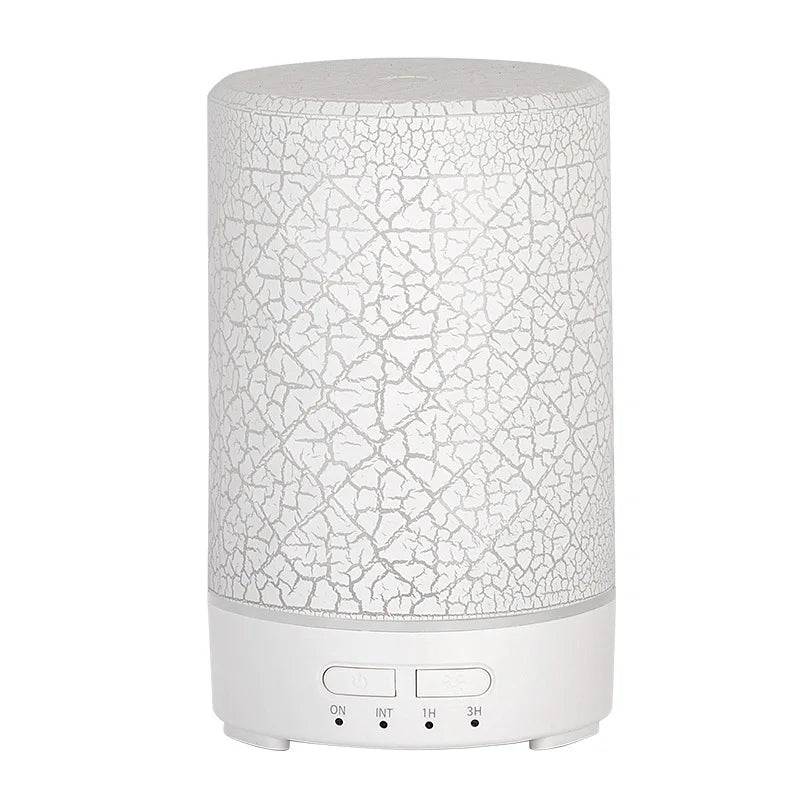 Modern cylindrical aromatherapy diffuser with an all-white minimalist base and crackle effect.