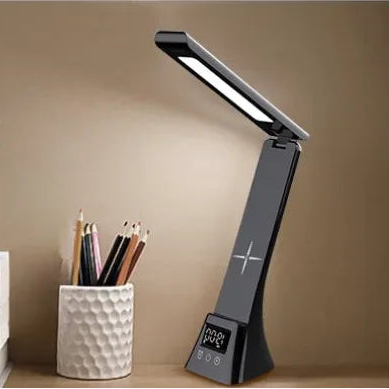 Two table lamps, one white and one black, on a desk with stationery items.