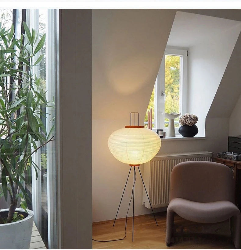 Modern interior with a Japanese floor lamp, chair, and window view