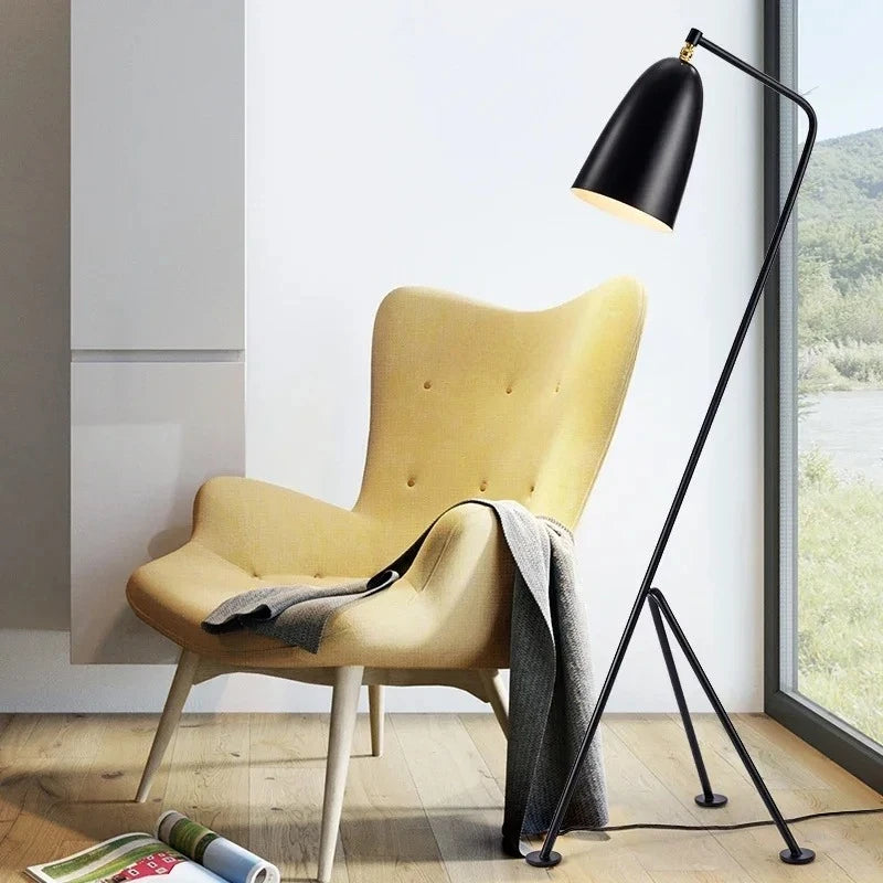 Yellow armchair with a black floor lamp in a modern room.