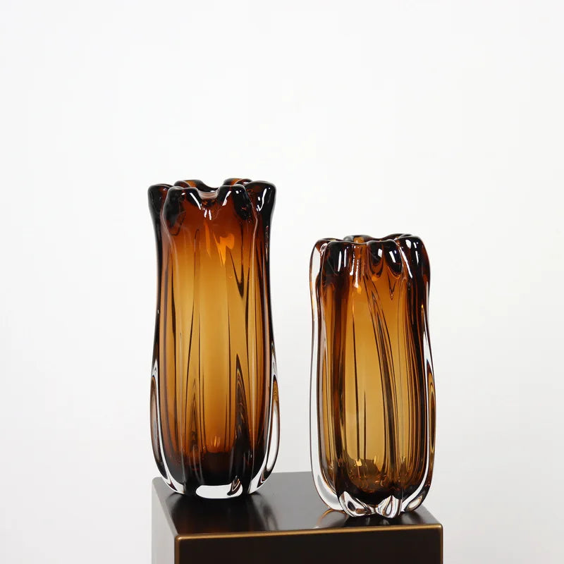 Two thick amber crystal glass vases in small and large sizes, featuring organic wavy rims and vertical textures.