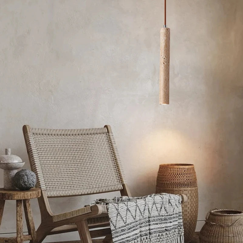 Wicker chair with a textured pendant light in a neutral setting