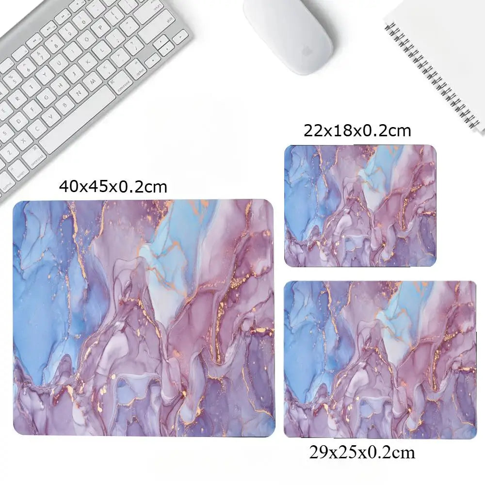 Marble-patterned mouse pad with dimensions displayed on a desk setup.