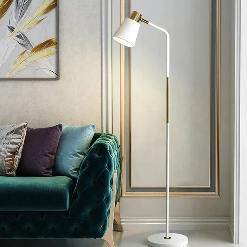 White Nordic floor lamp with slim metal body and brass detail
