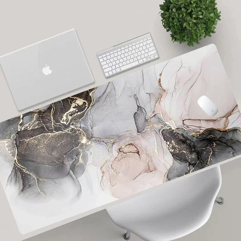Marble-patterned desk with laptop, keyboard, and chair in a modern office setting