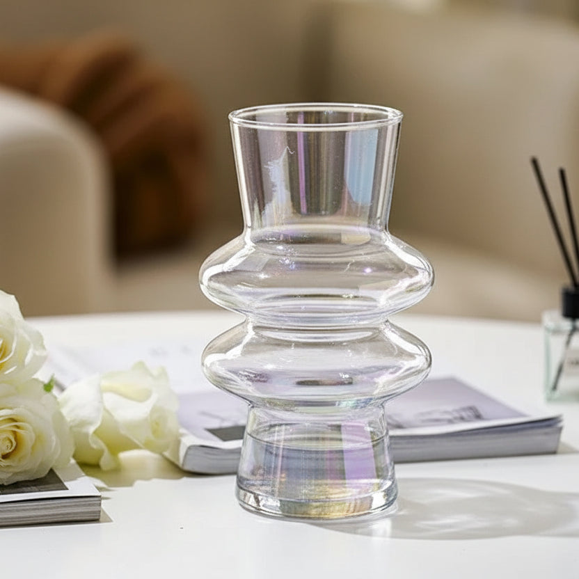 Clear glass vase with dimensions on a magazine on a table