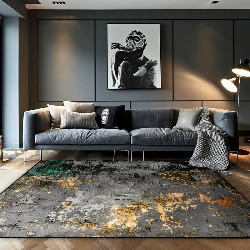 Large grey abstract area rug with gold and green ink wash detail in a dark modern living room with grey sofa