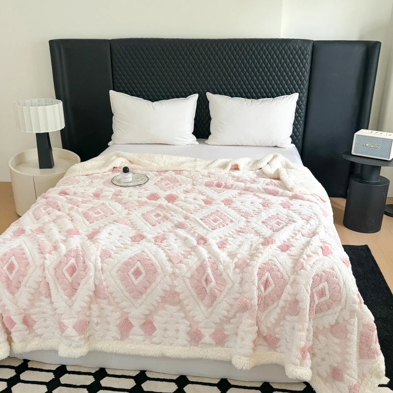 Bed with pink and white patterned blanket, black headboard, and side tables.