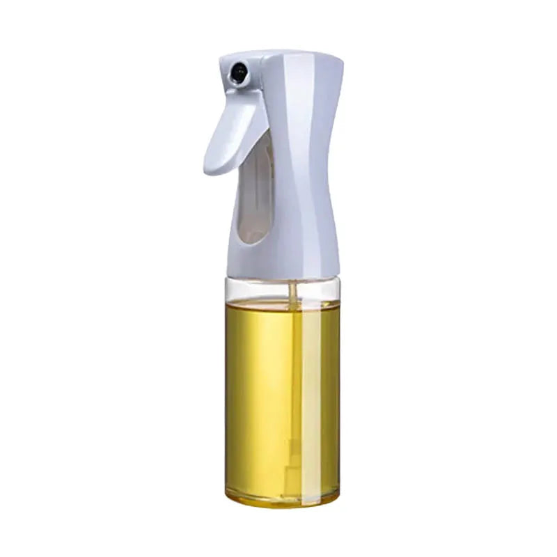Spray bottle with a white nozzle and clear container filled with oil on a white background