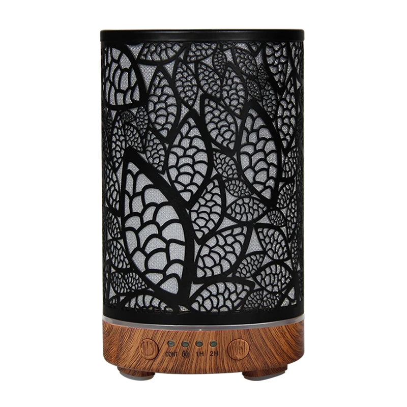 Black leaf pattern essential oil diffuser with dark wood grain base and intricate cutouts.