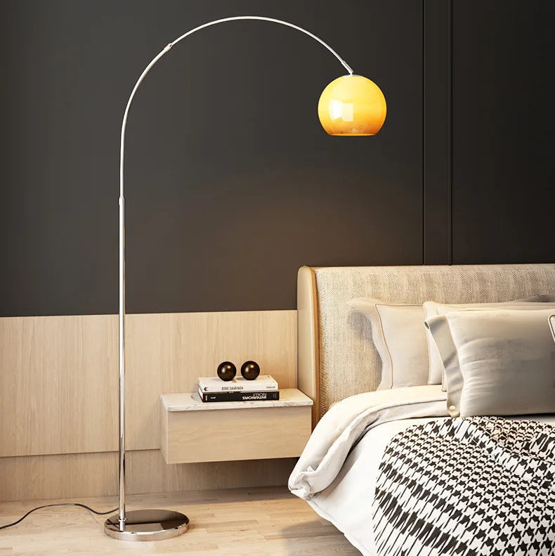 Modern bedroom with a standing lamp and bed.