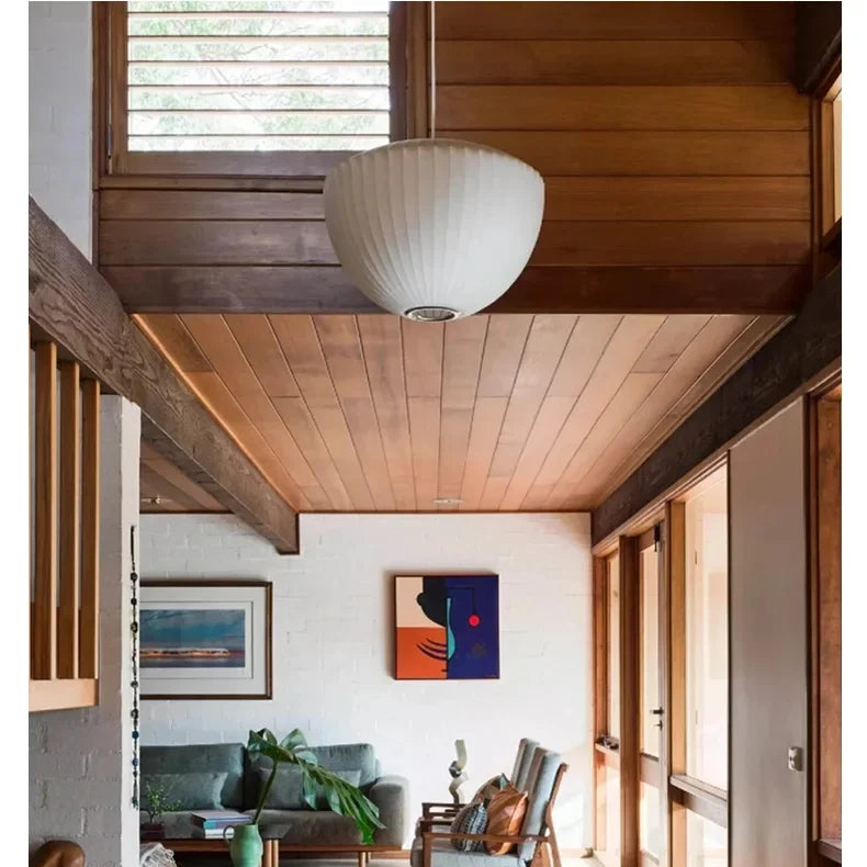 White silk pendant ceiling light in a warm wood interior hallway