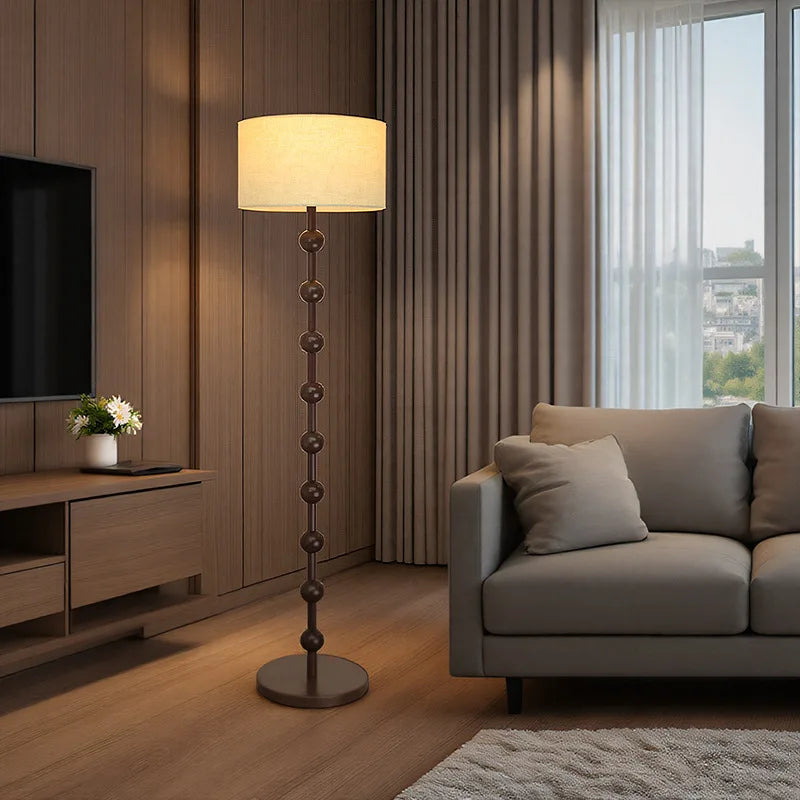 Living room with a floor lamp, sofa, and television.