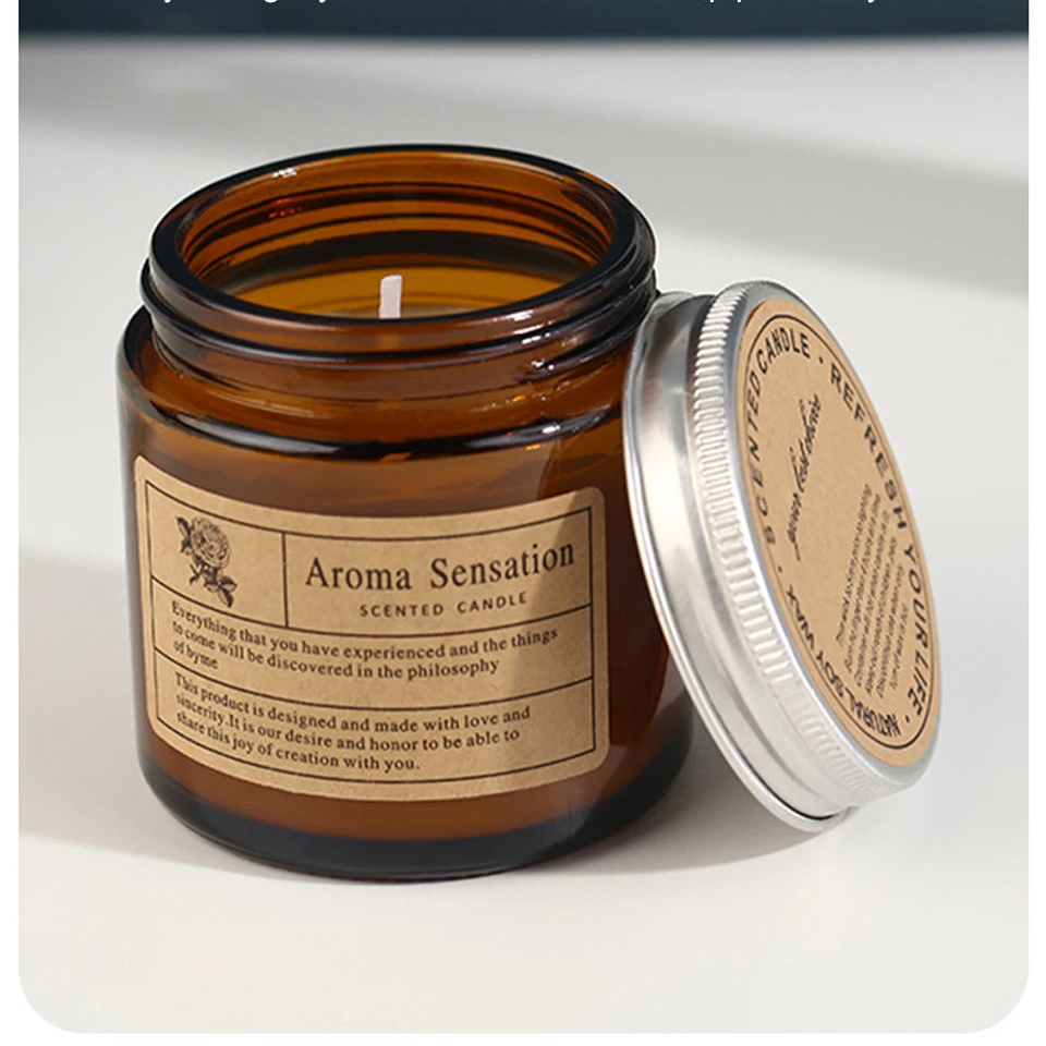 Aroma Sensation scented candle in a glass jar with a metal lid on a white background.