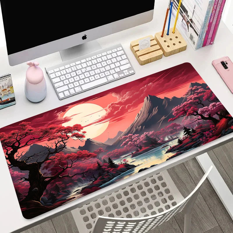 Large desk mat with vivid red blossom trees, mountains, and a glowing sunrise reflected in a river