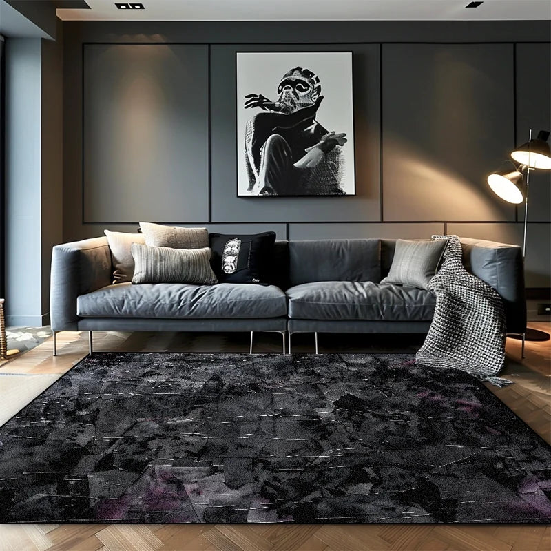 Deep black abstract area rug with subtle purple shadow tones and silver fleck detail in a moody modern living room