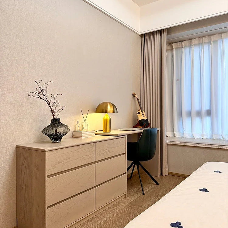 Modern bedroom with a dresser, desk, and bed.