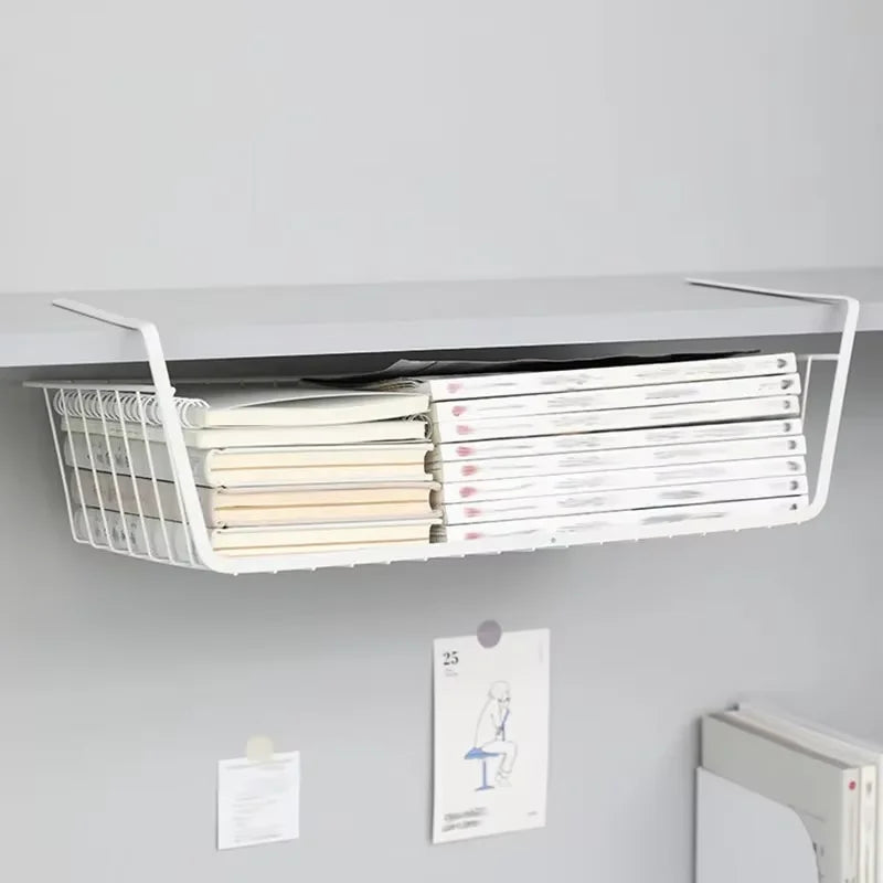 White hanging magazine rack with books on a gray wall.
