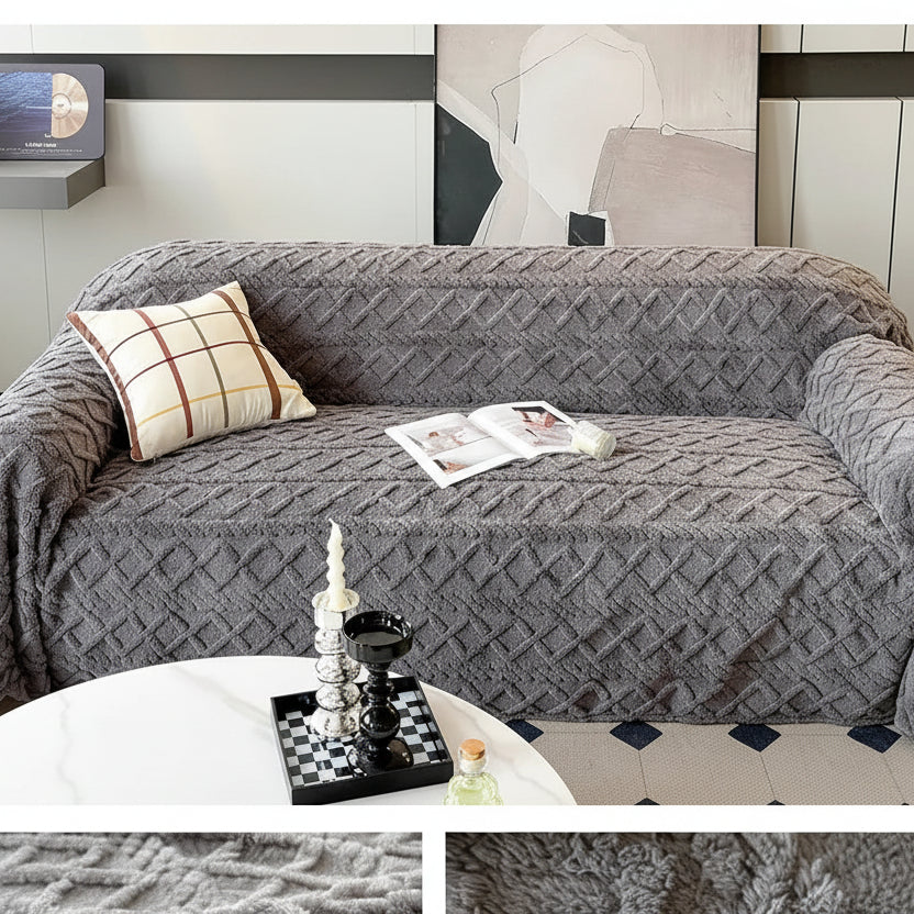 Gray sofa with textured cover and decorative items in a living room setting.