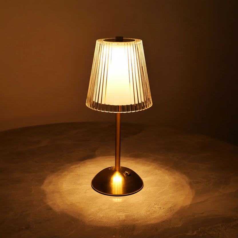Table lamp with pleated shade on a dark background