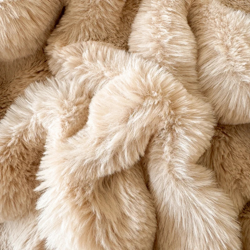 Close-up of beige fluffy fabric textured blanket