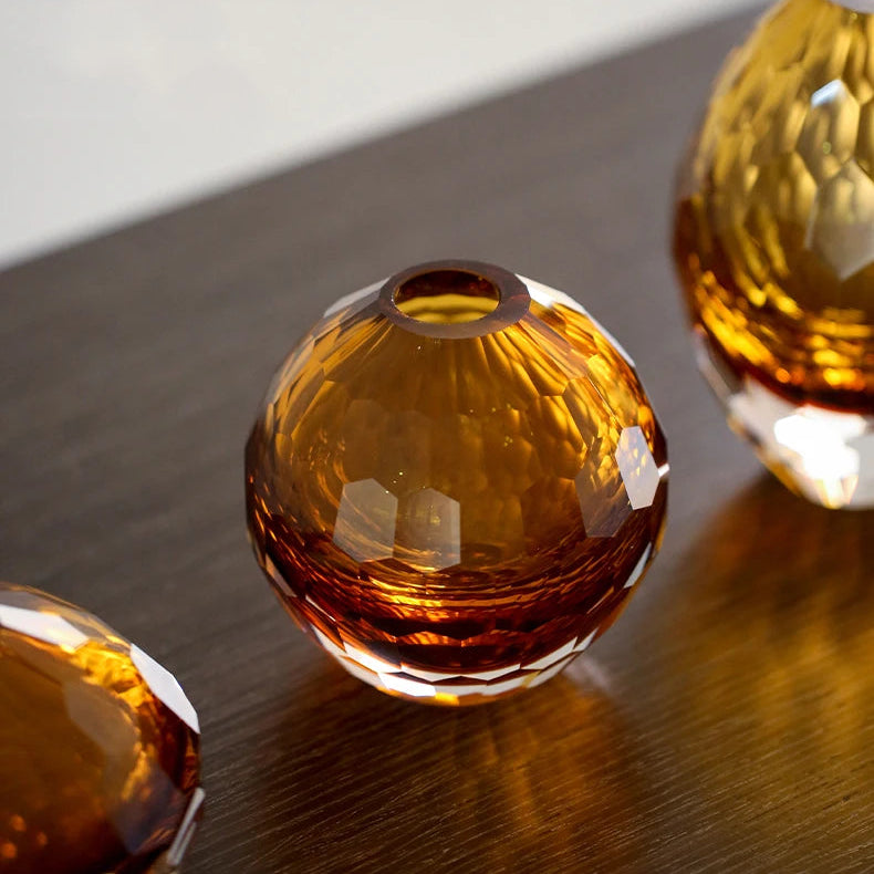 Amber glass beads on a reflective surface with a neutral background