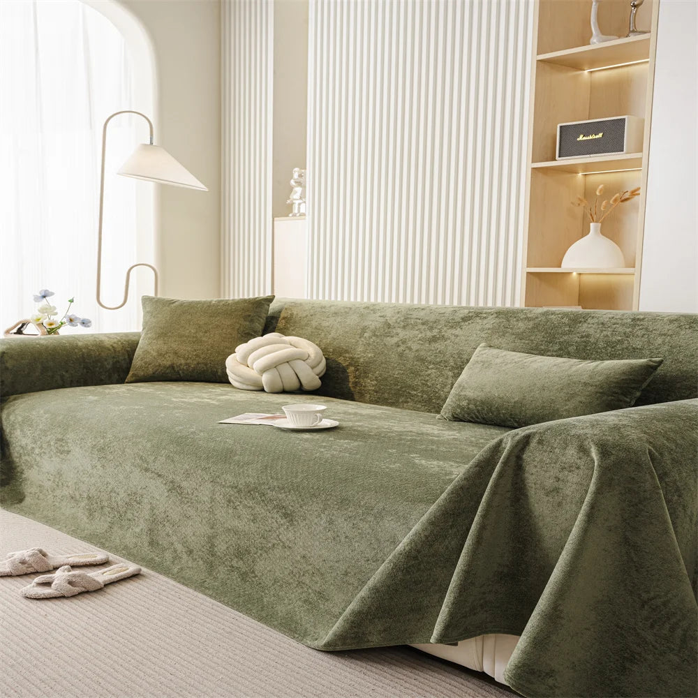 Soft-touch olive sofa throw styled in a minimalist living room