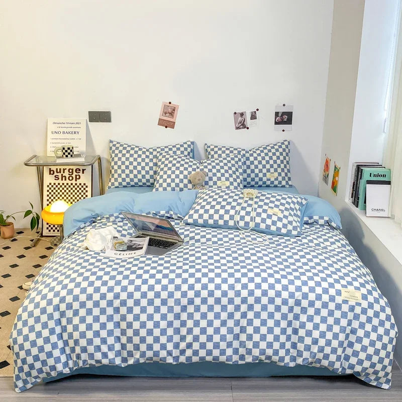 Sky blue and white checkerboard duvet cover set with matching pillowcases dressed on a double bed in a modern styled bedroom