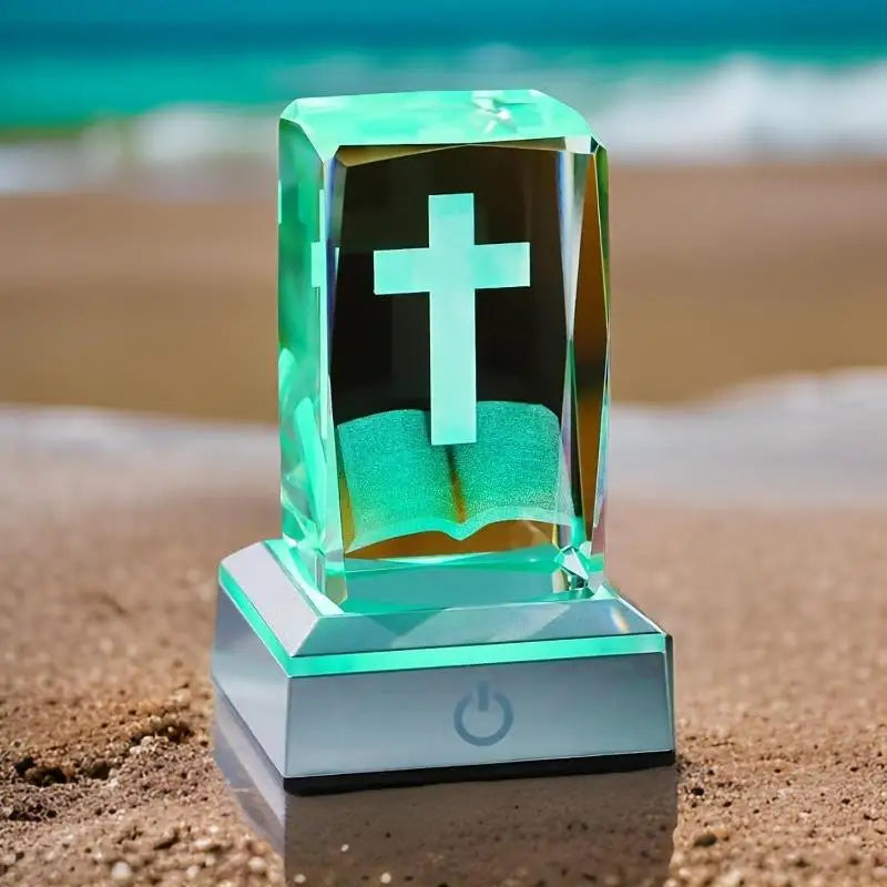 Crystal-like device with a cross on a beach