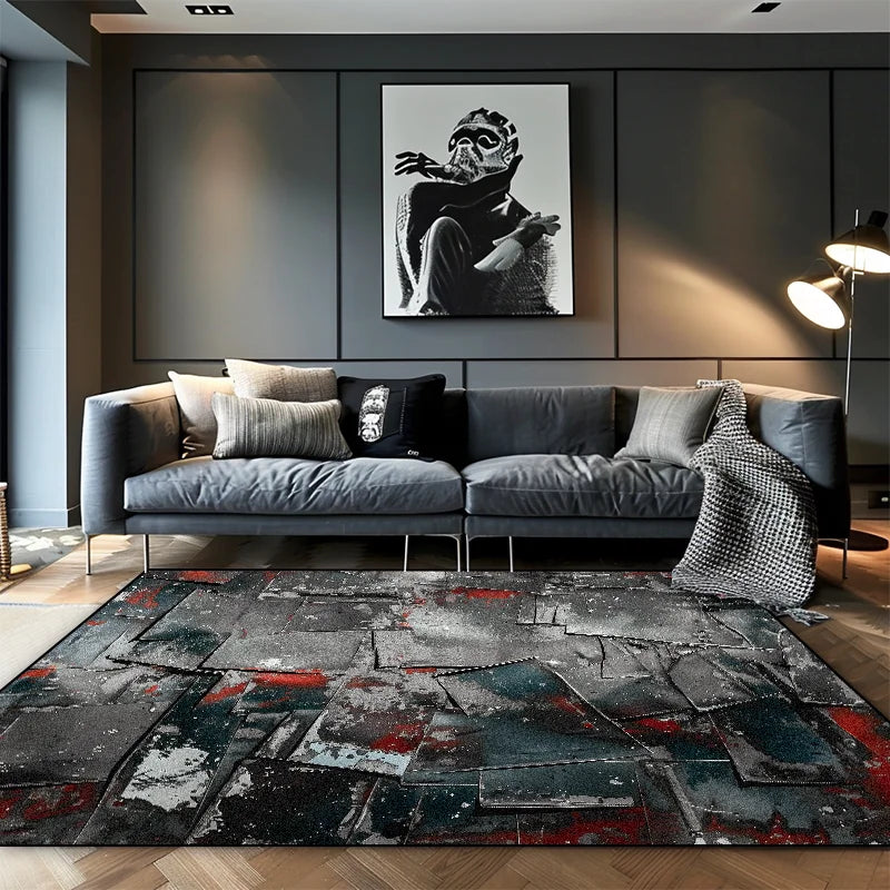 Grey geometric shatter abstract area rug with red and teal splatter detail in a dark contemporary living room