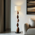 Spiral wooden floor lamp with stacked twisted base and cream fabric shade
