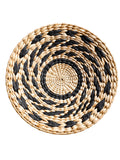 Round woven mat with black and beige pattern, showing dimensions on a white background