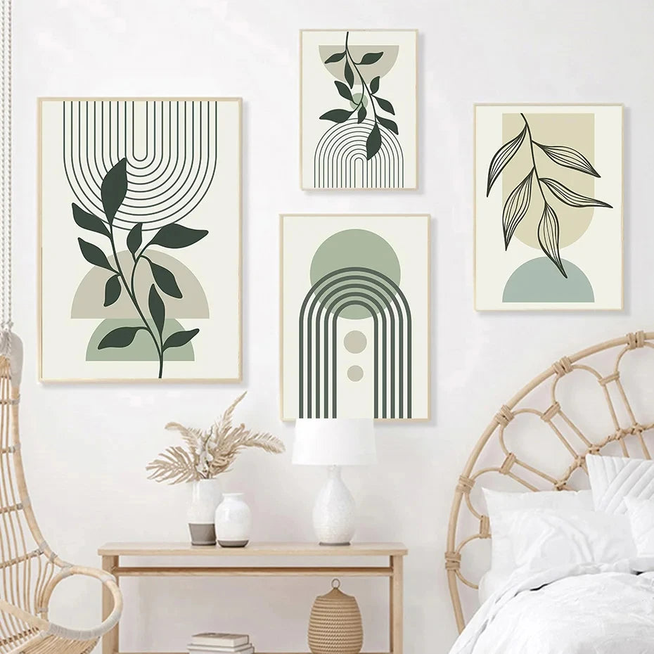 Set of four abstract wall art prints with green and beige colors in a bedroom setting.